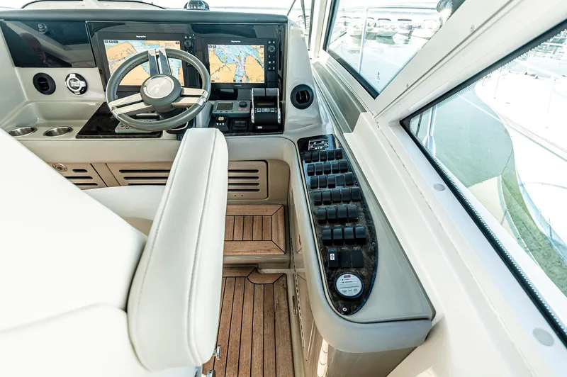 At's Ahmibote V Yacht Photos Pics Helm of 2011 Sea Ray 580 Sundancer with navigation screens and controls.