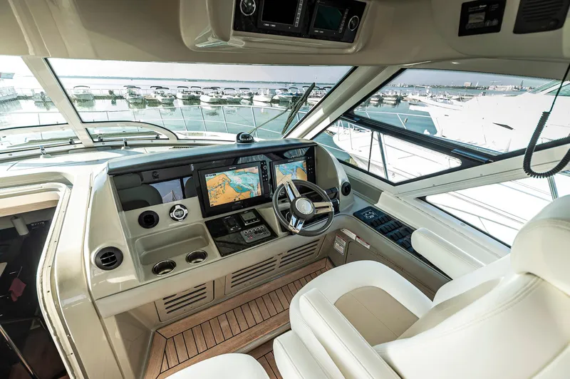 At's Ahmibote V Yacht Photos Pics 2011 Sea Ray 580 Sundancer helm with modern navigation displays and luxurious seating.