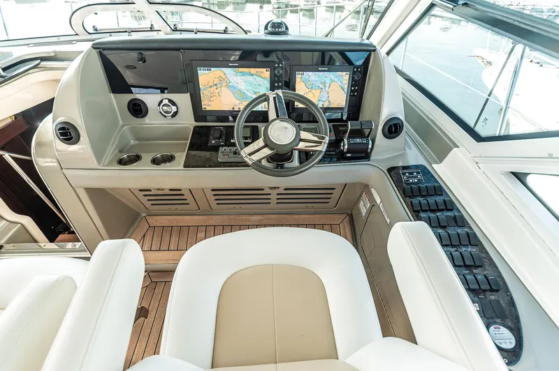 At's Ahmibote V Yacht Photos Pics Helm of 2011 Sea Ray 580 Sundancer with dual navigation screens and modern controls.