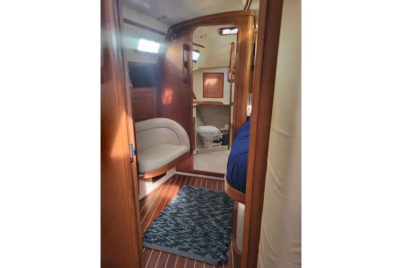 Catharpin Blue Yacht Photos Pics Interior of 1984 Island Packet 420 yacht, featuring cozy seating and a compact bathroom.