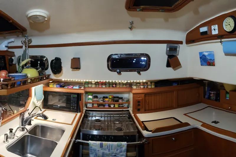 Catharpin Blue Yacht Photos Pics Cozy 1984 Island Packet 420 yacht kitchen with stove, sink, and spice rack.