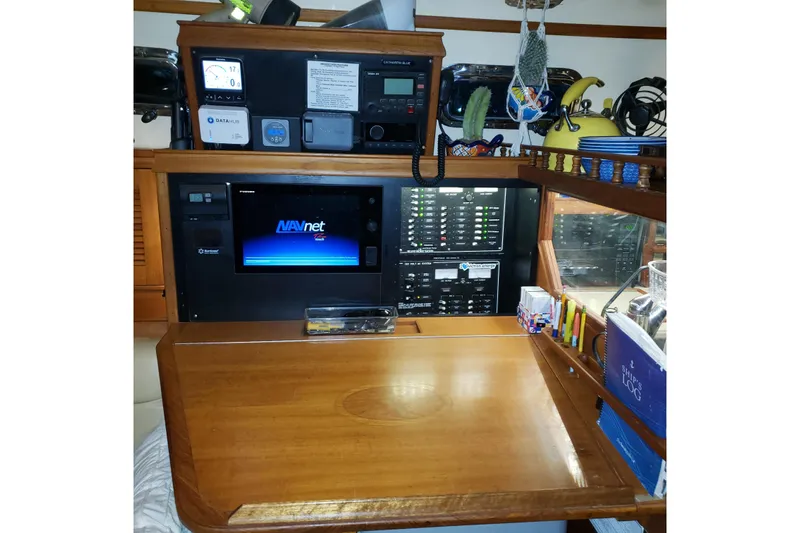 Catharpin Blue Yacht Photos Pics Navigation station of a 1984 Island Packet 420 sailboat with electronic equipment and storage.