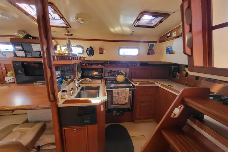 Catharpin Blue Yacht Photos Pics Cozy 1984 Island Packet 420 yacht interior with wooden kitchen and dining area.