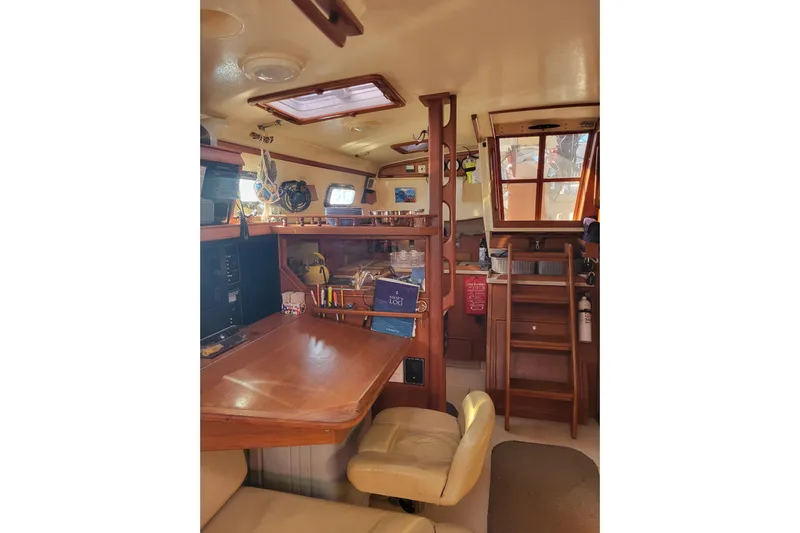 Catharpin Blue Yacht Photos Pics Interior of 1984 Island Packet 420 sailboat with wooden furnishings and navigation equipment.