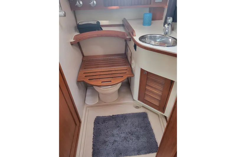 Catharpin Blue Yacht Photos Pics Bathroom interior of 1984 Island Packet 420 yacht with wooden accents and sink.