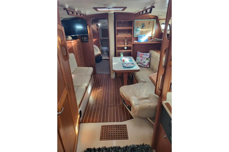 Catharpin Blue Yacht Photos Pics Interior of 1984 Island Packet 420 yacht with cozy seating and wooden finishes.