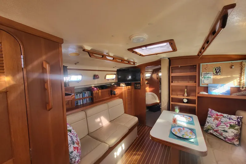 Catharpin Blue Yacht Photos Pics Interior of 1984 Island Packet 420 sailboat with cozy seating and wooden finishes.