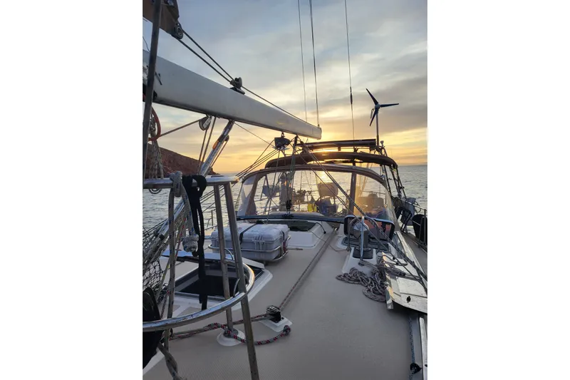 Catharpin Blue Yacht Photos Pics Sailing yacht Island Packet 420, 1984 model, at sunset on calm waters.