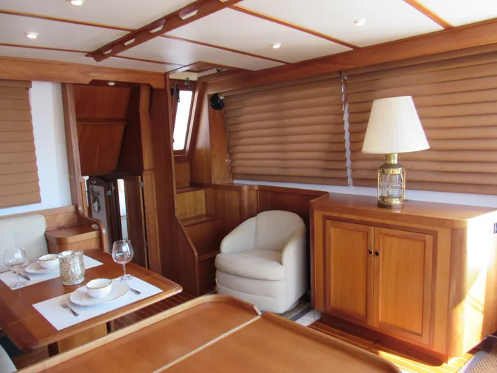 Candy O Yacht Photos Pics Interior of 1999 Sabre Sabreline 47 yacht with elegant wood finish and dining area.