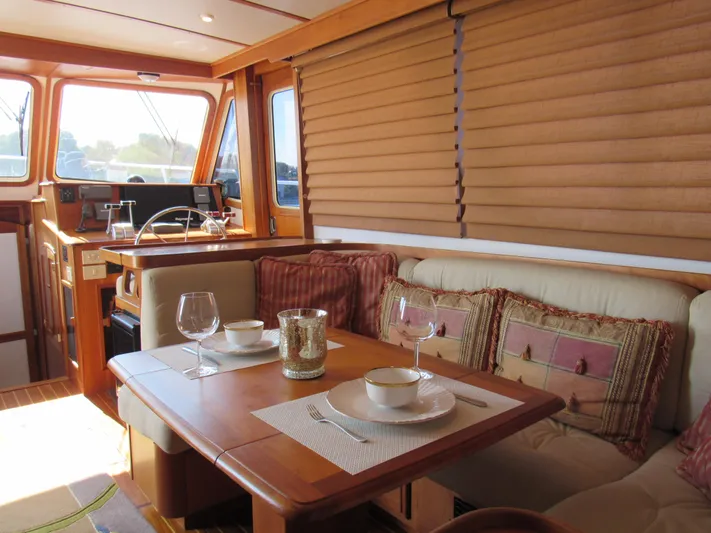 Candy O Yacht Photos Pics Interior of 1999 Sabreline 47 yacht with elegant dining area and cozy seating.