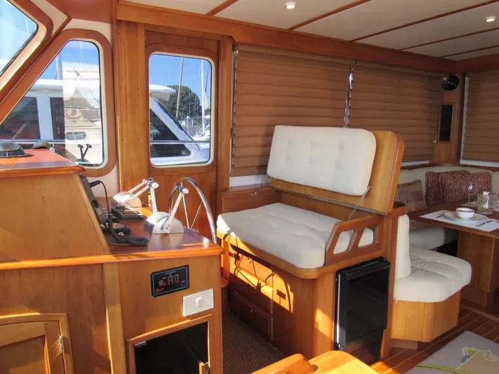 Candy O Yacht Photos Pics Interior of 1999 Sabreline 47 yacht with wooden finish and comfortable seating.