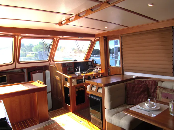 Candy O Yacht Photos Pics Interior of 1999 Sabreline 47 yacht with wood finish and cozy seating area.