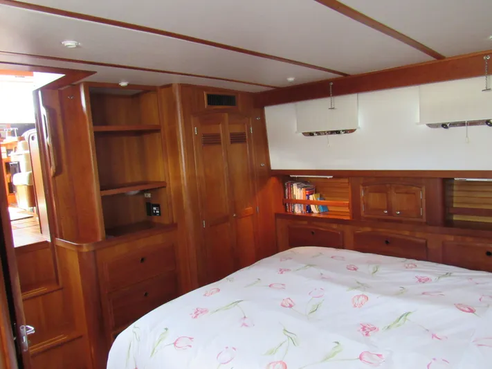 Candy O Yacht Photos Pics Cozy bedroom in 1999 Sabre Sabreline 47 yacht with wooden cabinetry and floral bedding.