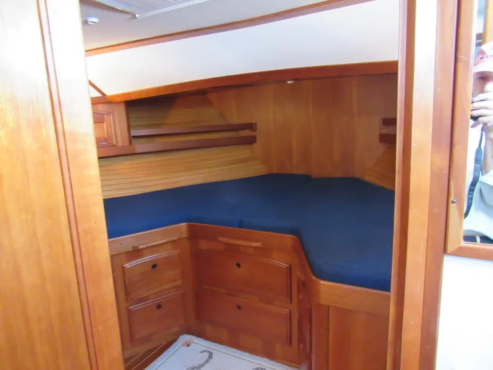 Candy O Yacht Photos Pics 1999 Sabreline 47 yacht cabin with wooden interior and blue bedding.