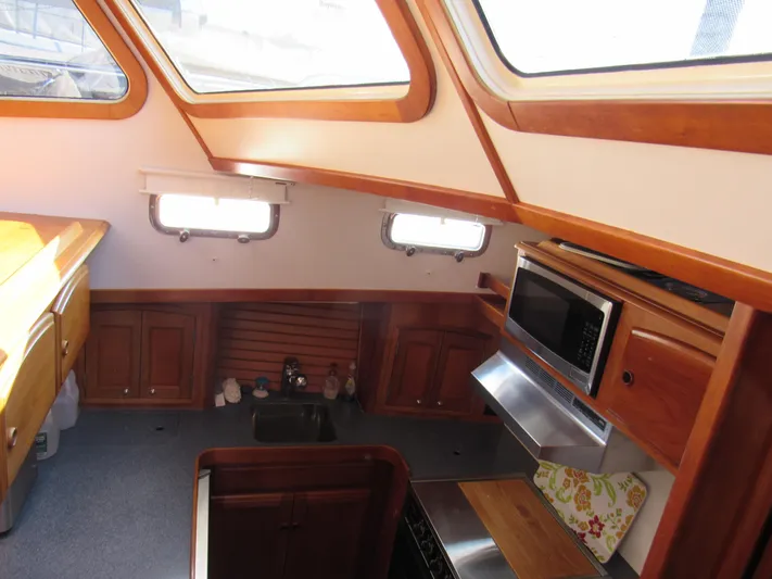 Candy O Yacht Photos Pics Interior of 1999 Sabre Sabreline 47 yacht kitchen with wood cabinetry and skylights.