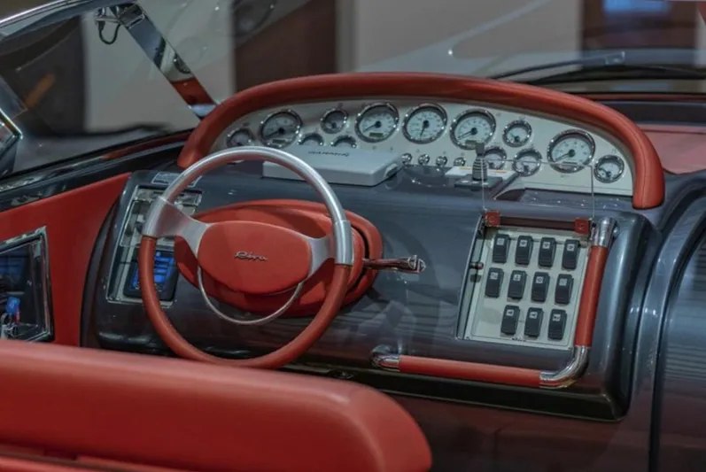  Yacht Photos Pics Dashboard of a 2013 Riva Aquariva 33 with red leather accents and classic gauges.