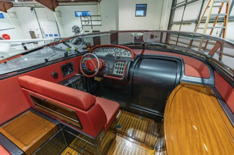  Yacht Photos Pics Interior of 2013 Riva Aquariva 33 boat with red leather seating and wooden dashboard.