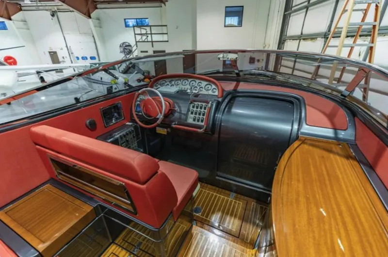  Yacht Photos Pics 2013 Riva Aquariva 33 boat interior with red seating and wooden accents.