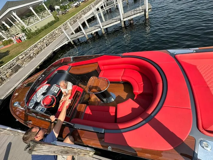  Yacht Photos Pics 2013 Riva Aquariva 33 with luxurious red seating docked by a lakeside pier.