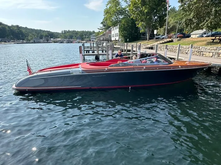  Yacht Photos Pics 2013 Riva Aquariva 33 luxury boat docked on a serene lake.