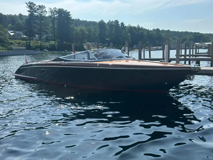  Yacht Photos Pics 2013 Riva Aquariva 33 boat docked on a serene lake.