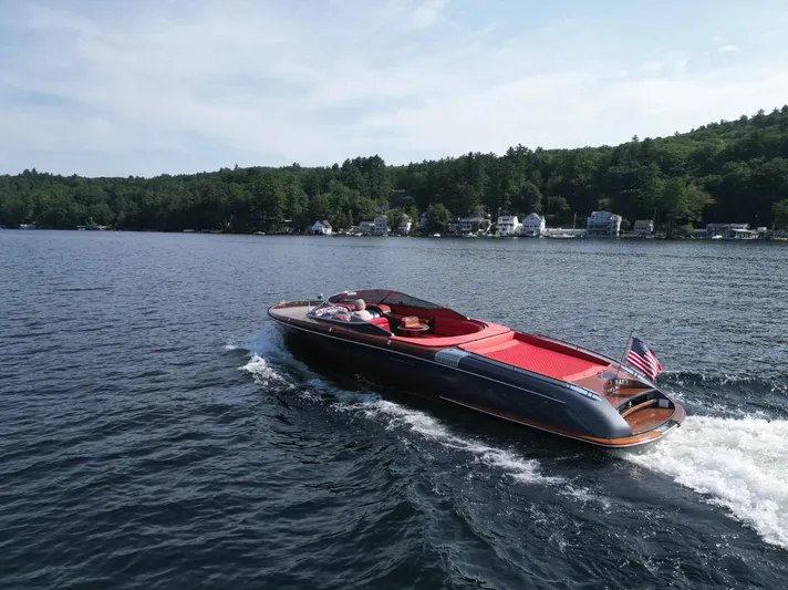  Yacht Photos Pics 2013 Riva Aquariva 33 cruising on a scenic lake with lush green shoreline.