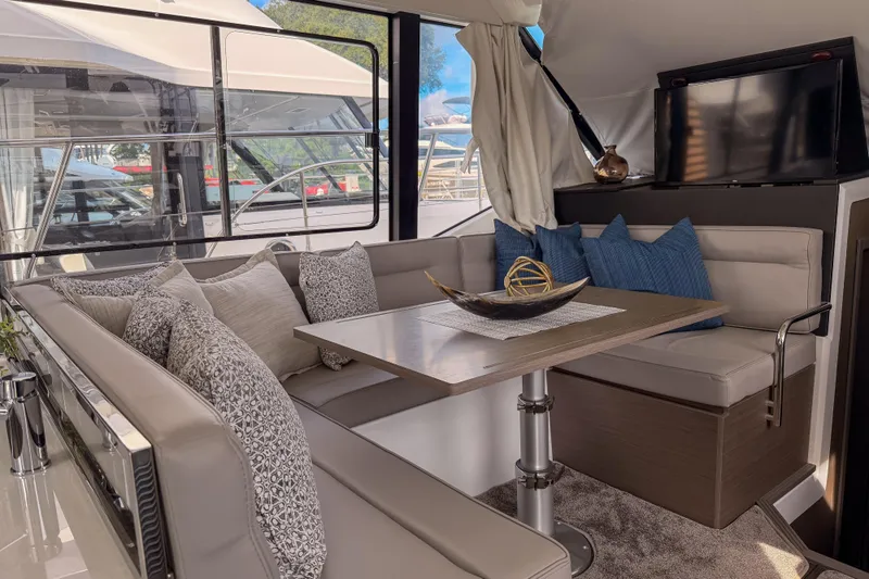 Rhapsody In Sea Yacht Photos Pics Luxurious interior of 2025 Jeanneau NC 1295 Fly yacht with elegant seating and decor.