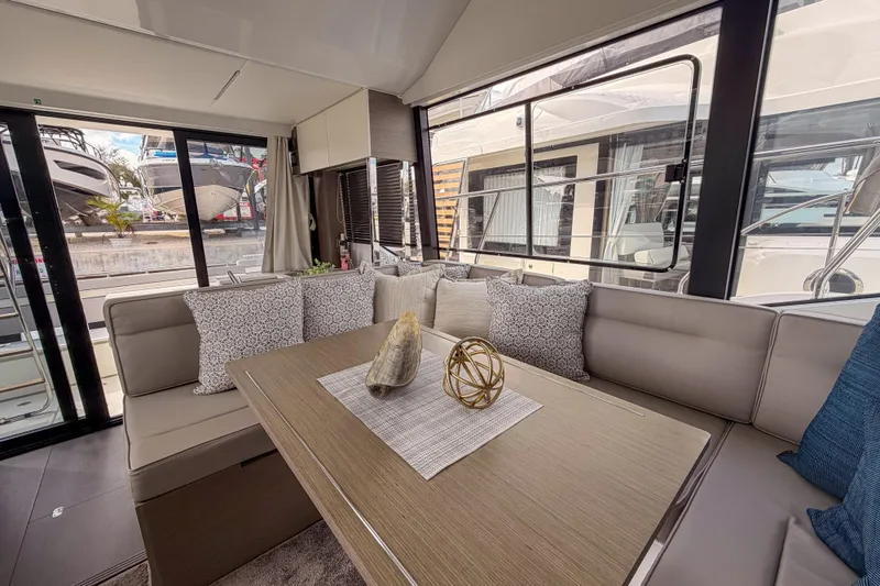 Rhapsody In Sea Yacht Photos Pics Interior of 2025 Jeanneau NC 1295 Fly yacht with elegant seating and decor.