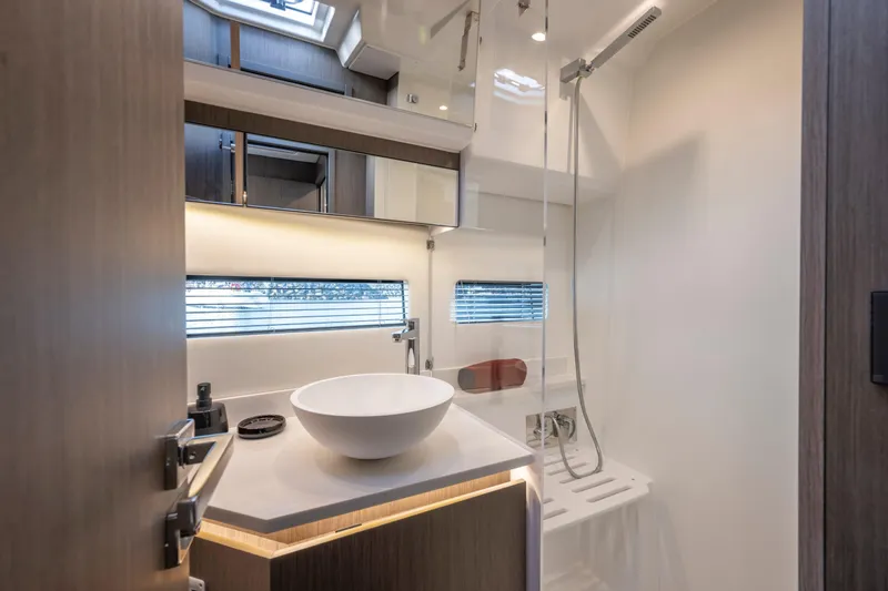 Rhapsody In Sea Yacht Photos Pics Modern bathroom interior of 2025 Jeanneau NC 1295 Fly yacht, featuring sleek design and elegant fixtures.