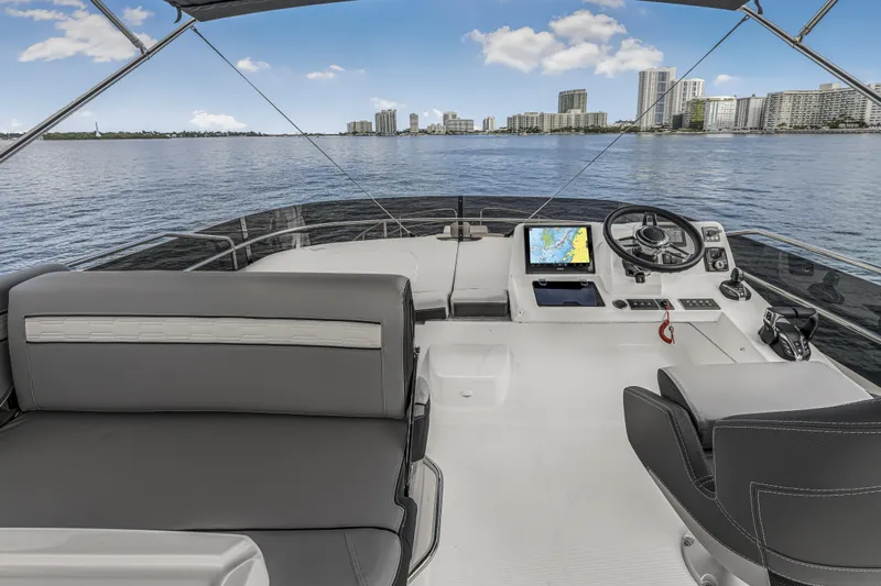 Rhapsody In Sea Yacht Photos Pics Flybridge of 2025 Jeanneau NC 1295 Fly yacht with city skyline view.