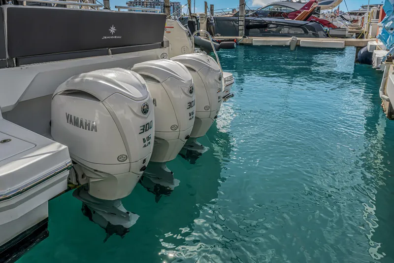 Rhapsody In Sea Yacht Photos Pics 2025 Jeanneau NC 1295 Fly with Yamaha 300 V6 engines docked in marina.