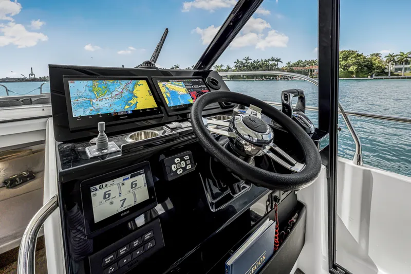 Rhapsody In Sea Yacht Photos Pics Cockpit of 2025 Jeanneau NC 1295 Fly with navigation screens and steering wheel.