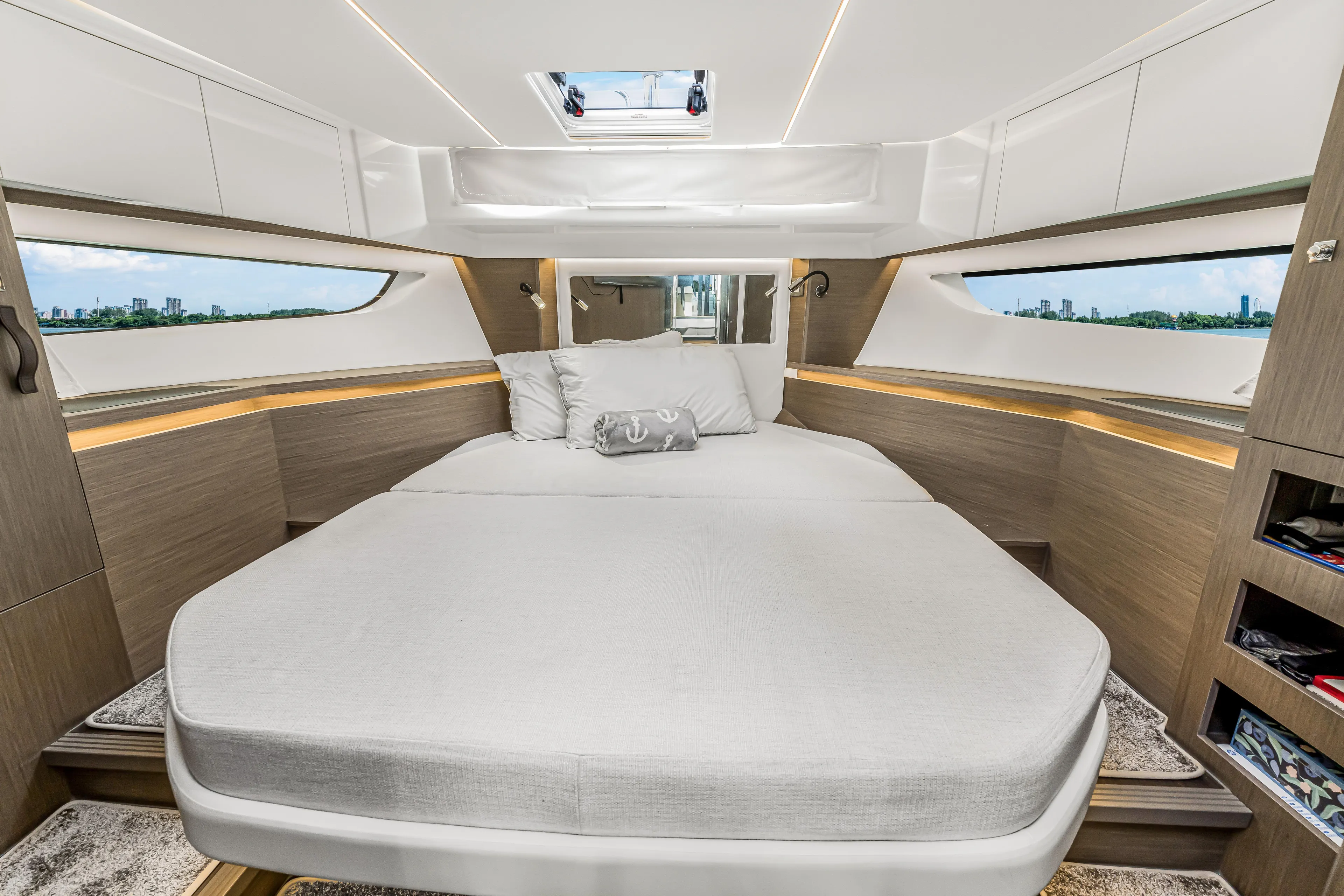 Rhapsody In Sea Yacht Photos Pics Luxurious cabin interior of 2025 Jeanneau NC 1295 Fly yacht with panoramic windows.