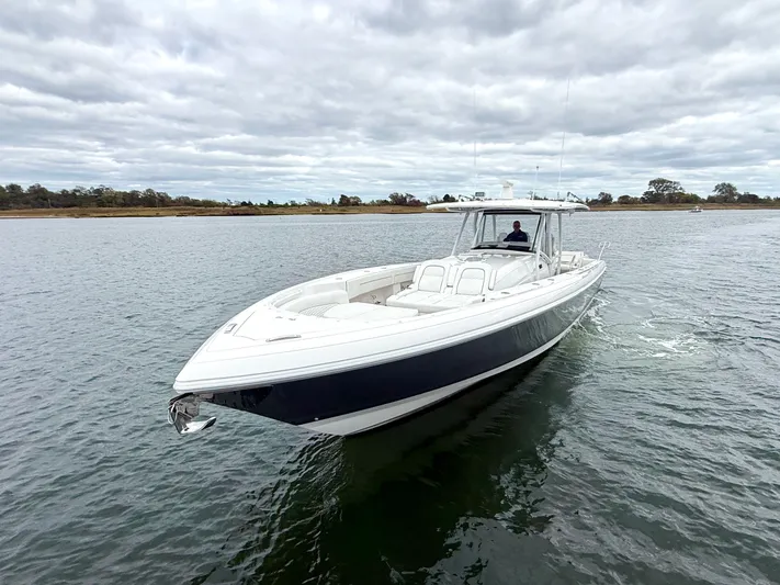 Panacea Yacht Photos Pics 2019 Intrepid 475 Panacea boat cruising on a calm, cloudy day.