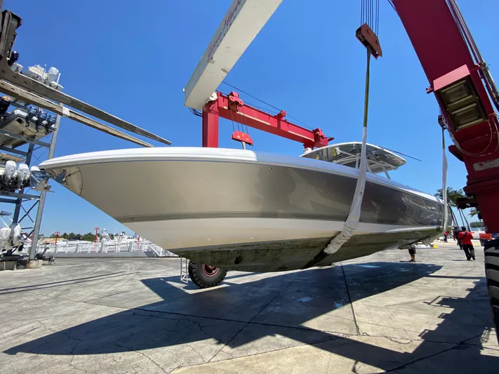 Panacea Yacht Photos Pics 2019 Intrepid 475 Panacea boat being lifted by crane at a marina.