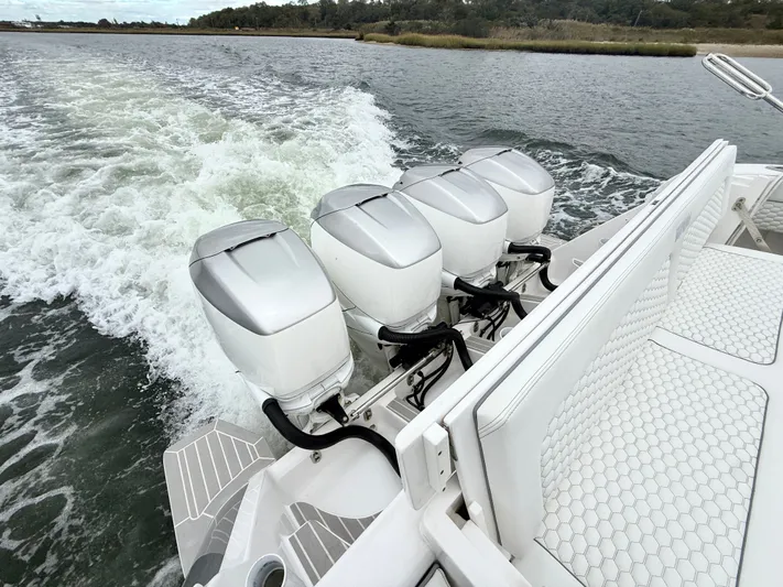 Panacea Yacht Photos Pics 2019 Intrepid 475 Panacea with four powerful outboard engines cruising on water.