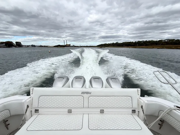Panacea Yacht Photos Pics 2019 Intrepid 475 Panacea cruising on water, leaving a wake under cloudy skies.
