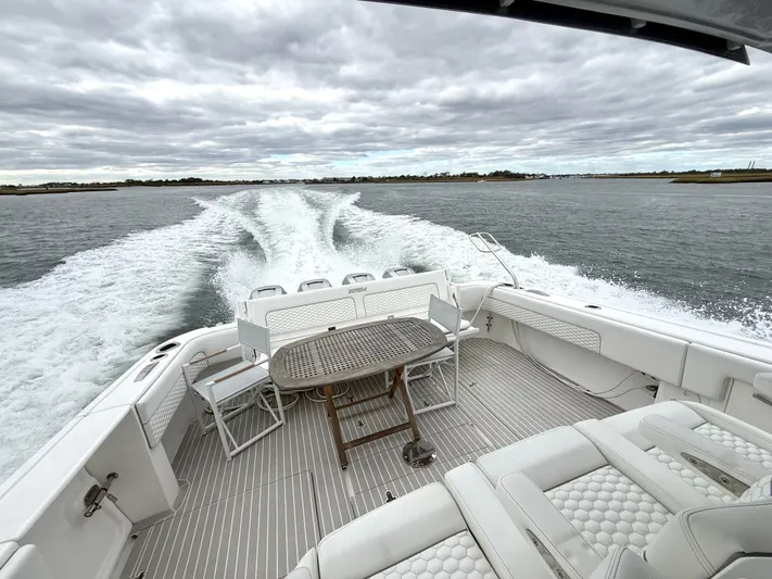 Panacea Yacht Photos Pics 2019 Intrepid 475 Panacea cruising on open water, showcasing spacious deck and seating.
