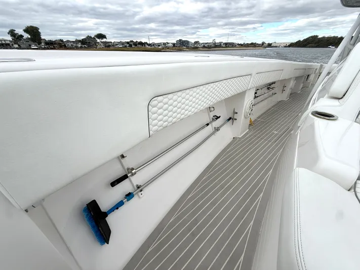 Panacea Yacht Photos Pics 2019 Intrepid 475 Panacea boat deck with storage compartments and cleaning tools.