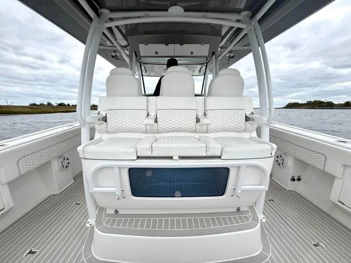 Panacea Yacht Photos Pics 2019 Intrepid 475 Panacea boat interior with white seating and sleek design on open water.