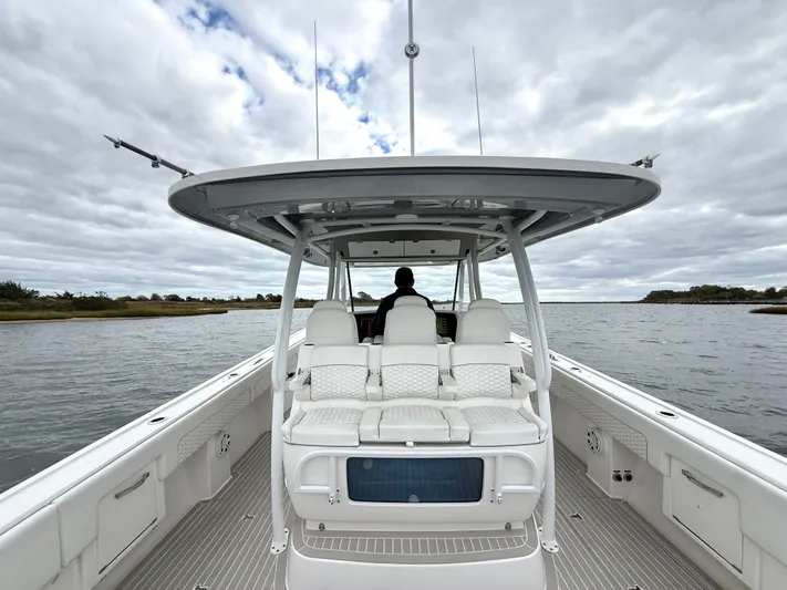 Panacea Yacht Photos Pics 2019 Intrepid 475 Panacea boat cruising on a calm waterway under cloudy skies.