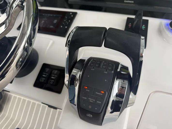 Panacea Yacht Photos Pics Control panel of a 2019 Intrepid 475 Panacea boat with throttle and navigation controls.