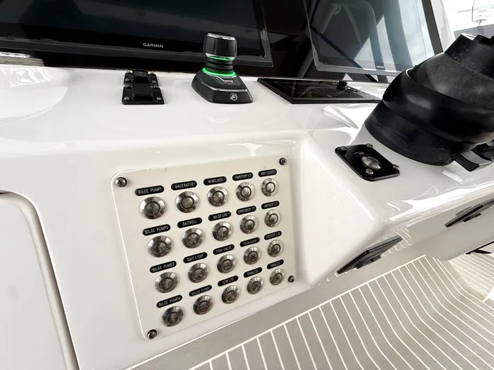 Panacea Yacht Photos Pics Control panel of a 2019 Intrepid 475 Panacea boat with labeled switches and Garmin display.