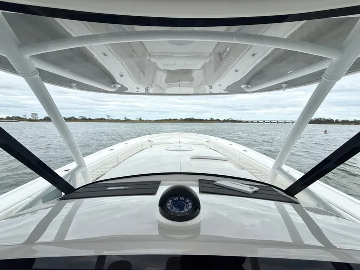 Panacea Yacht Photos Pics 2019 Intrepid 475 Panacea boat navigating calm waters under cloudy skies.