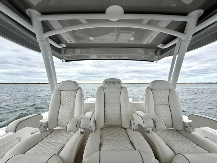Panacea Yacht Photos Pics Luxurious seating on 2019 Intrepid 475 Panacea boat, featuring elegant white upholstery.