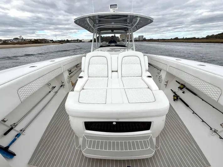 Panacea Yacht Photos Pics 2019 Intrepid 475 Panacea boat interior with white seating and fishing rods.