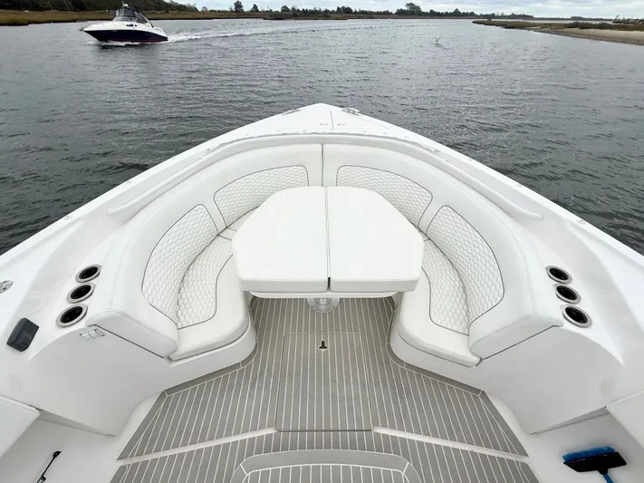 Panacea Yacht Photos Pics 2019 Intrepid 475 Panacea boat with white seating and table on calm water.