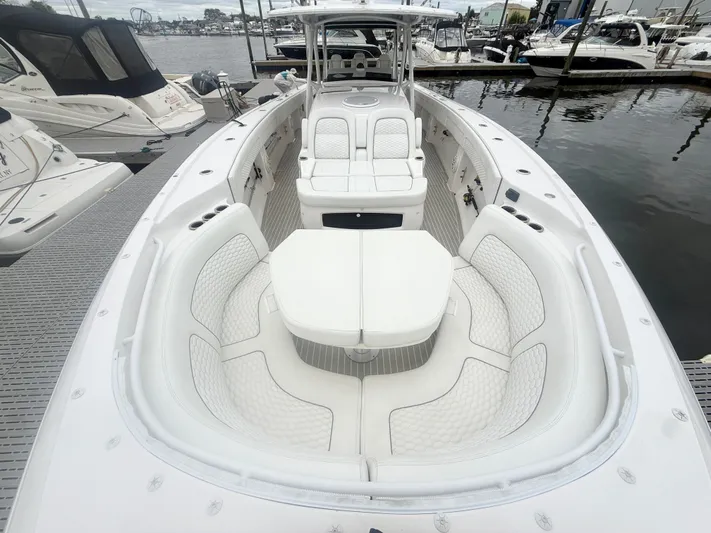 Panacea Yacht Photos Pics 2019 Intrepid 475 Panacea boat with luxurious white seating at a marina.
