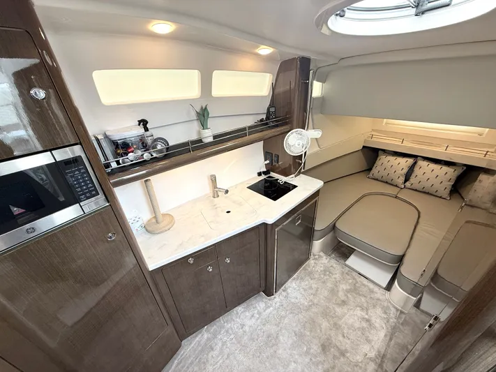 Panacea Yacht Photos Pics Luxurious interior of 2019 Intrepid 475 Panacea yacht with modern kitchenette and cozy seating area.