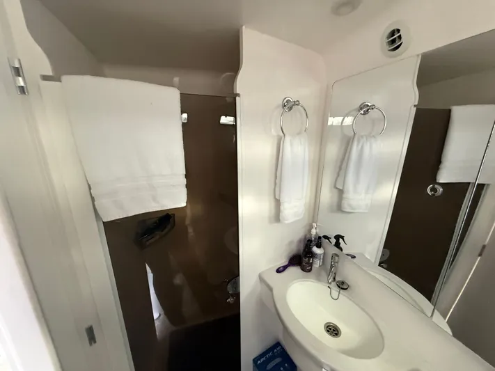 Panacea Yacht Photos Pics Bathroom interior of 2019 Intrepid 475 Panacea with sink, mirror, and towels.